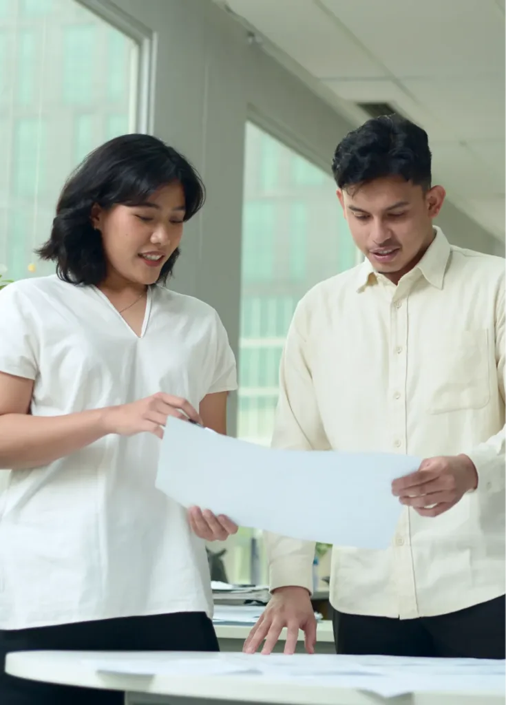 Two TTW colleagues reviewing project documents in Jakarta