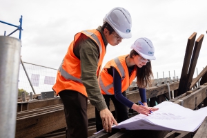 Engineers reviewing construction drawings on site