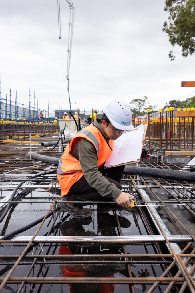 Engineer inspecting steel reinforcement on a construction site
