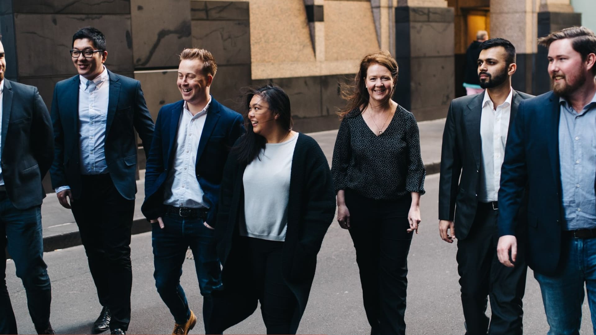 TTW team walking together along a city laneway in business attire